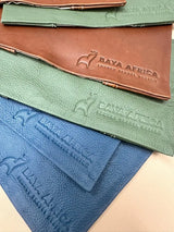 Brown leather travel pouch with embossed ’baya africa’ logo and elephant design.