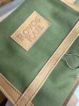 Olive green canvas tote bag with tan leather trim and a stitched leather patch reading ’rovos rail’